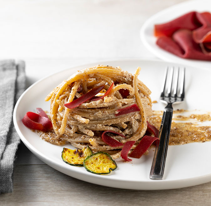 Whole wheat spaghetti with walnut and zucchini sauce